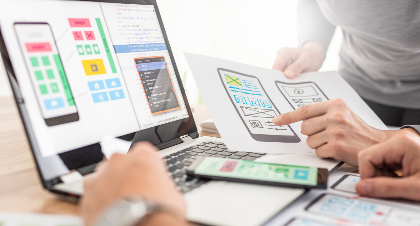 Mobile App Designers Discussing Wireframe Drafts